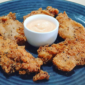 Fried chicken ribs served with dipping sauce at Hendrick's